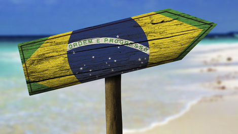 Brazil flag wooden sign with a beach on background